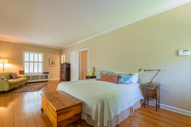 1286 W Stephenson St, Freeport, IL 61032 - bedroom featuring radiator heating unit, wood finished floors, and ornamental molding