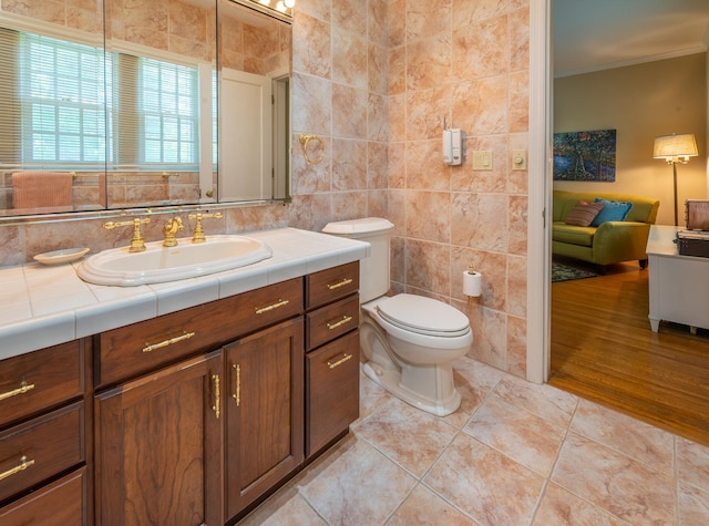 1286 W Stephenson St, Freeport, IL 61032 - bathroom featuring vanity, crown molding, and tile walls
