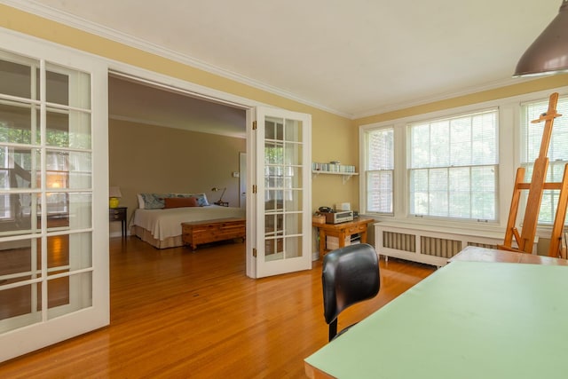 1286 W Stephenson St, Freeport, IL 61032 - bedroom featuring french doors, wood finished floors, radiator, ornamental molding, and a desk