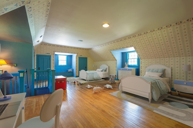 1286 W Stephenson St, Freeport, IL 61032 - bedroom with wallpapered walls, wood finished floors, multiple windows, and lofted ceiling
