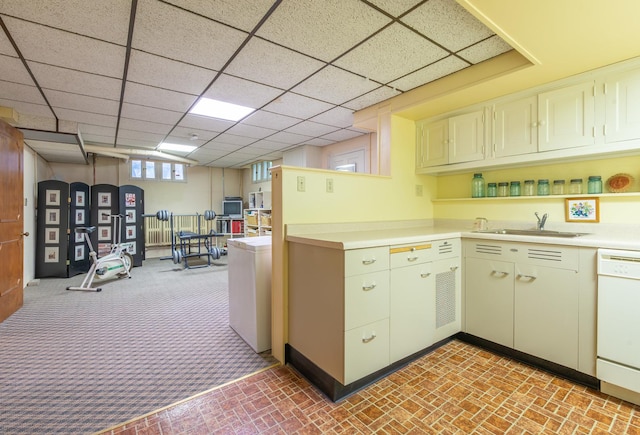 1286 W Stephenson St, Freeport, IL 61032 - kitchen featuring white dishwasher, brick patterned floors, light countertops, and a paneled ceiling