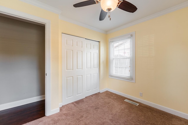 1614 E Dresser Rd, Dekalb, IL 60115 - unfurnished bedroom featuring crown molding, a closet, dark carpet, and a ceiling fan