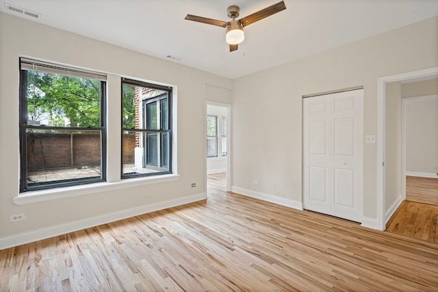 4557 S Michigan Ave Unit 1, Chicago, IL 60615 - unfurnished bedroom featuring light wood-style flooring, multiple windows, a closet, and a ceiling fan
