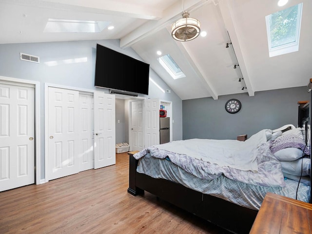385 E Irving Park Rd, Streamwood, IL 60107 - bedroom with a skylight, light wood-type flooring, freestanding refrigerator, two closets, and recessed lighting