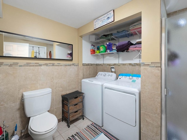 385 E Irving Park Rd, Streamwood, IL 60107 - bathroom featuring washer and clothes dryer, tile walls, tile patterned floors, a shower stall, and a wainscoted wall