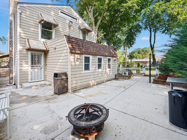 385 E Irving Park Rd, Streamwood, IL 60107 - back of property with an outdoor fire pit, a patio area, and a shingled roof