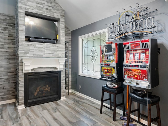 385 E Irving Park Rd, Streamwood, IL 60107 - living room featuring lofted ceiling, wood finished floors, and a fireplace