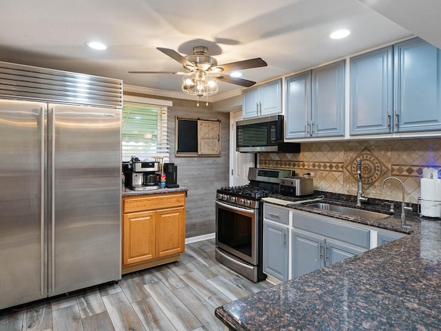 385 E Irving Park Rd, Streamwood, IL 60107 - kitchen with appliances with stainless steel finishes, a ceiling fan, dark stone counters, tasteful backsplash, and ornamental molding