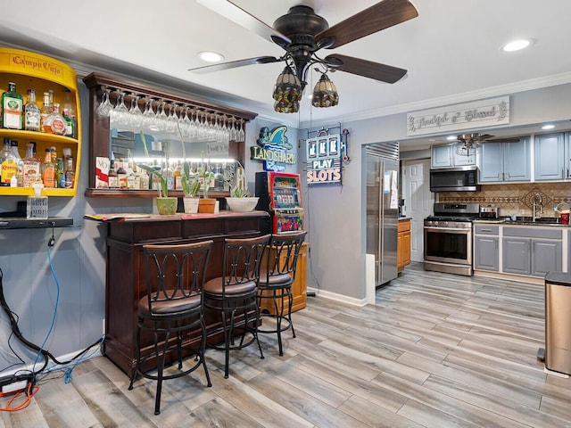 385 E Irving Park Rd, Streamwood, IL 60107 - indoor dry bar featuring stainless steel appliances, ceiling fan, ornamental molding, recessed lighting, and tasteful backsplash