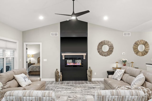 2621 Shale Rd, Normal, IL 61761 - living area featuring vaulted ceiling, wood finished floors, a large fireplace, and a ceiling fan
