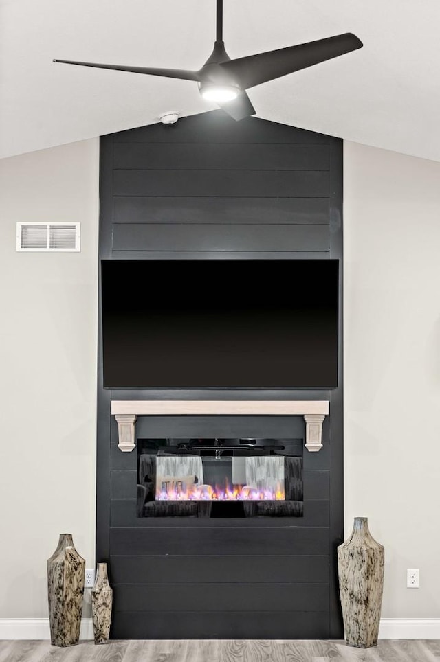 2621 Shale Rd, Normal, IL 61761 - detailed view of a glass covered fireplace, wood finished floors, a smoke detector, and ceiling fan