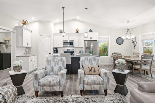 2621 Shale Rd, Normal, IL 61761 - living room with lofted ceiling, a chandelier, light wood finished floors, and recessed lighting