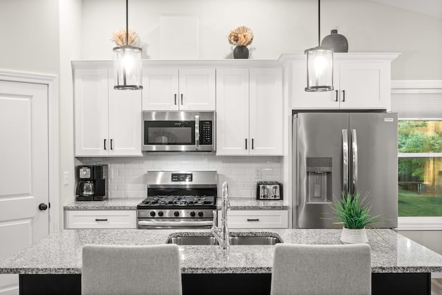 2621 Shale Rd, Normal, IL 61761 - kitchen with stainless steel appliances, white cabinetry, a center island with sink, and pendant lighting