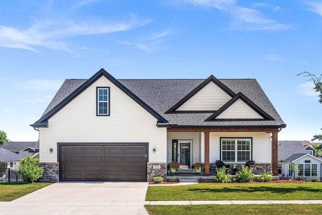2621 Shale Rd, Normal, IL 61761 - view of front of home with a garage, stone siding, a porch, and a shingled roof