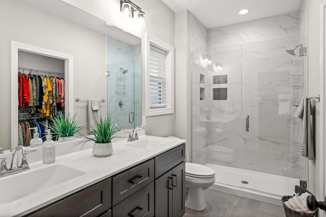2621 Shale Rd, Normal, IL 61761 - bathroom featuring a shower stall, double vanity, a spacious closet, and recessed lighting