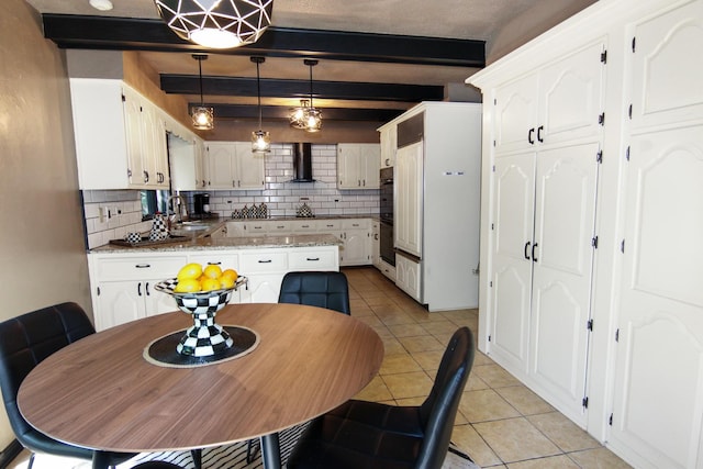 16612 S Catawba Rd, Homer Glen, IL 60491 - kitchen with beamed ceiling, wall chimney range hood, backsplash, light tile patterned flooring, and white cabinets