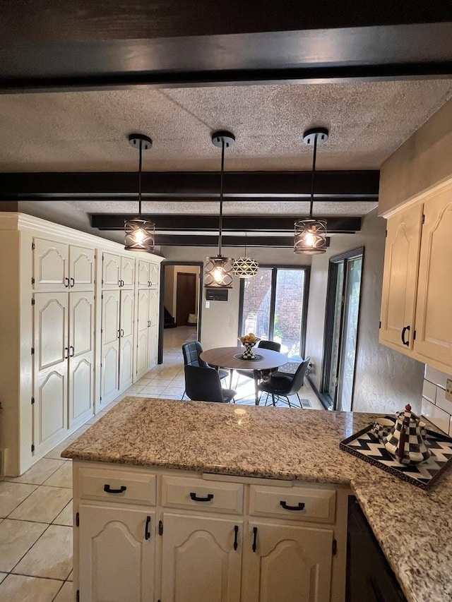 16612 S Catawba Rd, Homer Glen, IL 60491 - kitchen with light tile patterned floors, a peninsula, decorative light fixtures, beamed ceiling, and cooktop