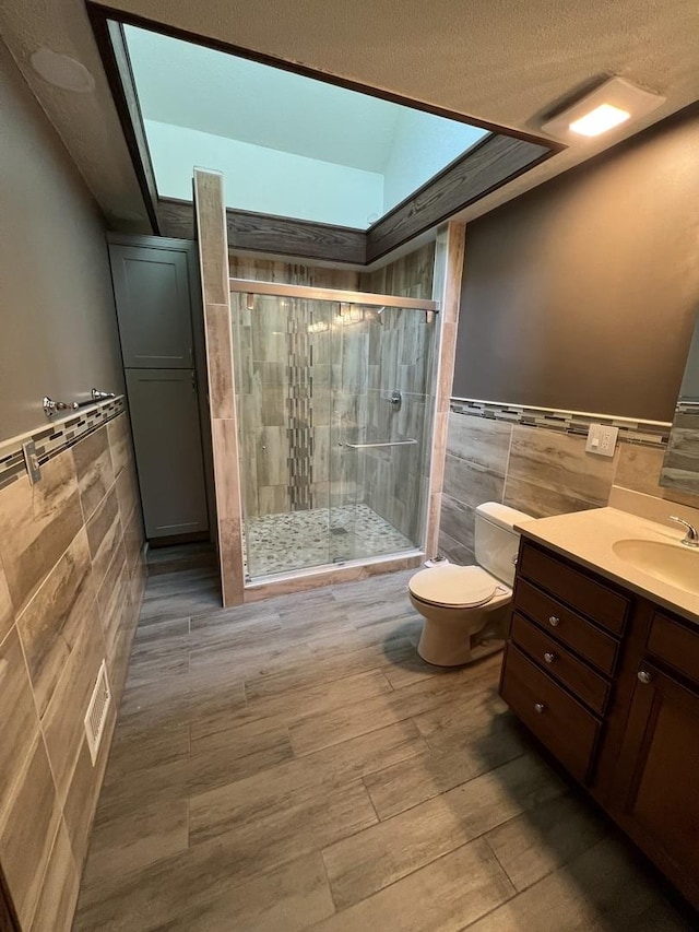16612 S Catawba Rd, Homer Glen, IL 60491 - full bath with tile walls, vanity, a shower stall, wainscoting, and wood finished floors