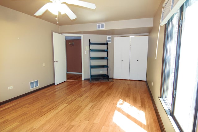 16612 S Catawba Rd, Homer Glen, IL 60491 - unfurnished bedroom featuring multiple windows, light wood-type flooring, a closet, and ceiling fan
