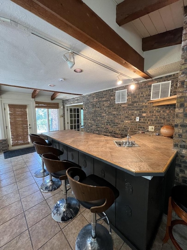 16612 S Catawba Rd, Homer Glen, IL 60491 - bar with beam ceiling, light tile patterned flooring, and a textured ceiling
