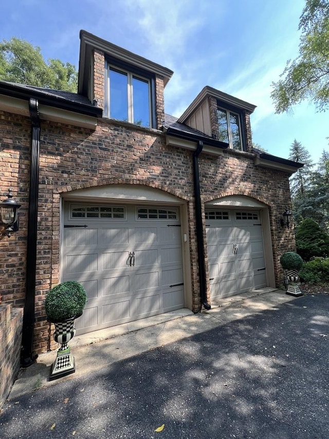 16612 S Catawba Rd, Homer Glen, IL 60491 - view of property exterior featuring an attached garage, asphalt driveway, and brick siding