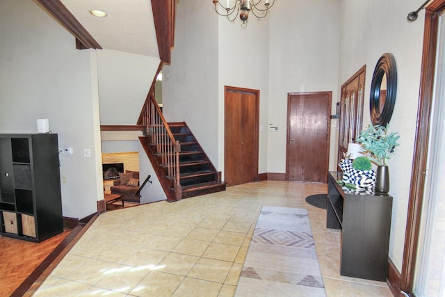 16612 S Catawba Rd, Homer Glen, IL 60491 - entrance foyer featuring stairs, a towering ceiling, a chandelier, light tile patterned floors, and a fireplace