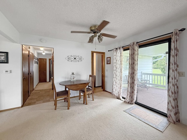 610 S 2nd Ave, Forreston, IL 61030 - dining room featuring light colored carpet, a ceiling fan, and a textured ceiling