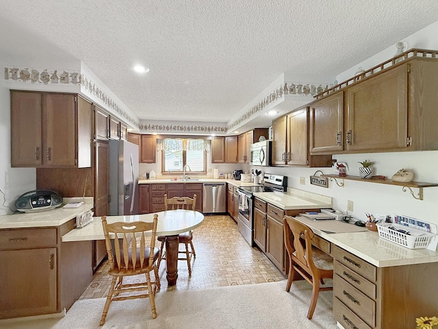 610 S 2nd Ave, Forreston, IL 61030 - kitchen with appliances with stainless steel finishes, a textured ceiling, light countertops, and recessed lighting