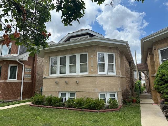4540 N Menard Ave, Chicago, IL 60630 - view of side of property with a yard and brick siding