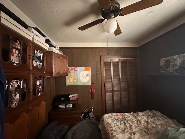 4540 N Menard Ave, Chicago, IL 60630 - bedroom featuring wood walls and a ceiling fan