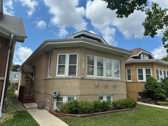 4540 N Menard Ave, Chicago, IL 60630 - view of side of home with brick siding and a lawn