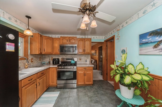 26477 Springwell St, Antioch, IL 60002 - kitchen featuring stainless steel appliances, light countertops, ceiling fan, and decorative backsplash