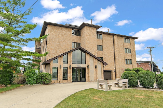 11020 S Keating Ave Unit 202, Oak Lawn, IL 60453 - view of property with concrete driveway and an attached garage