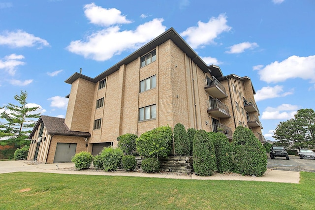 11020 S Keating Ave Unit 202, Oak Lawn, IL 60453 - view of property featuring a garage and concrete driveway