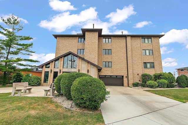 11020 S Keating Ave Unit 202, Oak Lawn, IL 60453 - view of building exterior with an attached garage and concrete driveway