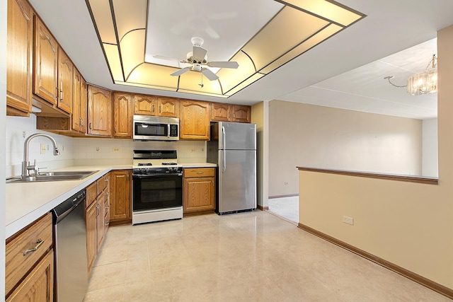 11020 S Keating Ave Unit 202, Oak Lawn, IL 60453 - kitchen with appliances with stainless steel finishes, brown cabinetry, ceiling fan, backsplash, and light countertops