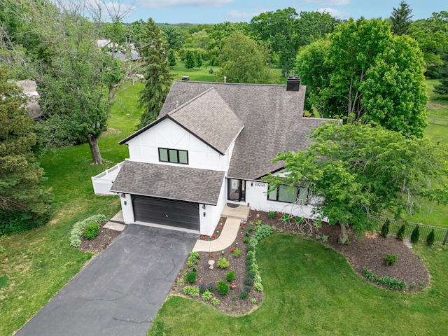 9N909 Koshare Trl, Elgin, IL 60124 - view of front facade with roof with shingles, an attached garage, driveway, a chimney, and stucco siding