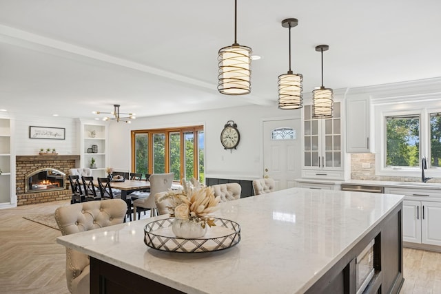 9N909 Koshare Trl, Elgin, IL 60124 - kitchen with open floor plan, white cabinets, decorative backsplash, light stone countertops, and pendant lighting