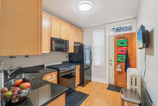4702 N Campbell Ave Unit 2, Chicago, IL 60625 - kitchen with stainless steel gas range oven, light brown cabinetry, black microwave, light wood-style flooring, and dark stone countertops