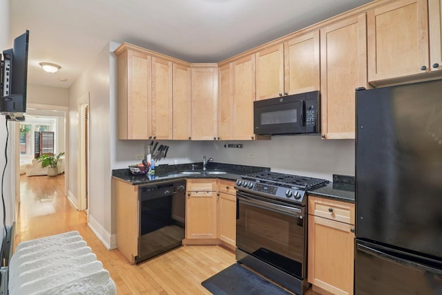 4702 N Campbell Ave Unit 2, Chicago, IL 60625 - kitchen with light brown cabinets, black appliances, light wood-style floors, and dark stone countertops