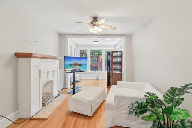 4702 N Campbell Ave Unit 2, Chicago, IL 60625 - living area featuring wood finished floors, ceiling fan, and a brick fireplace