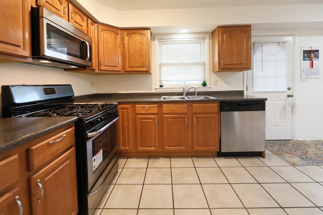 1065 Irwin Ave, Des Plaines, IL 60018 - kitchen featuring appliances with stainless steel finishes, dark countertops, brown cabinetry, recessed lighting, and light tile patterned floors