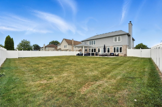 3705 Streamwood Dr, Hazel Crest, IL 60429 - rear view of house featuring a chimney, a fenced backyard, and a patio