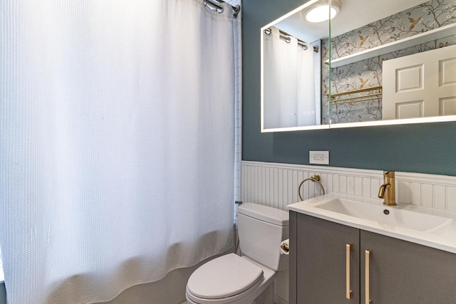 5952 N Paulina St Unit 2N, Chicago, IL 60660 - bathroom featuring a wainscoted wall, vanity, shower / bath combo with shower curtain, and wallpapered walls