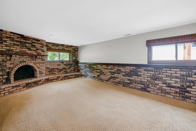 17720 Ashland Ave, Homewood, IL 60430 - unfurnished living room with brick wall, carpet floors, and a fireplace