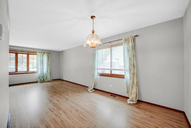 17720 Ashland Ave, Homewood, IL 60430 - spare room with plenty of natural light, a chandelier, and wood finished floors