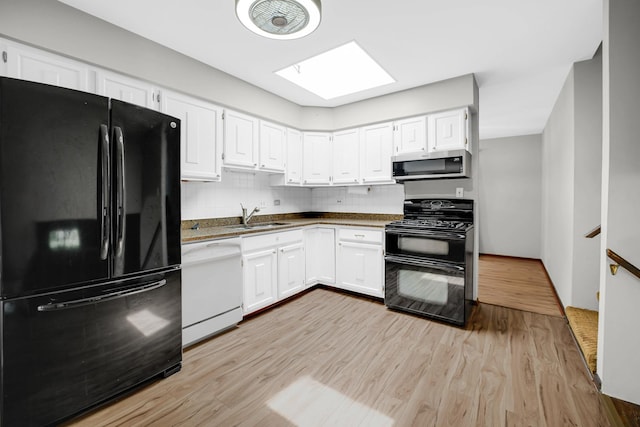 17720 Ashland Ave, Homewood, IL 60430 - kitchen featuring black appliances, light wood-style flooring, and white cabinetry