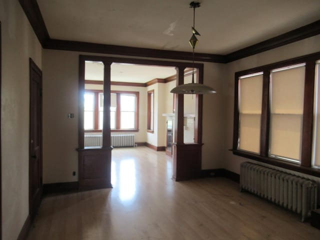 5822 S Sacramento Ave, Chicago, IL 60629 - unfurnished dining area with radiator, wood finished floors, ornamental molding, and decorative columns