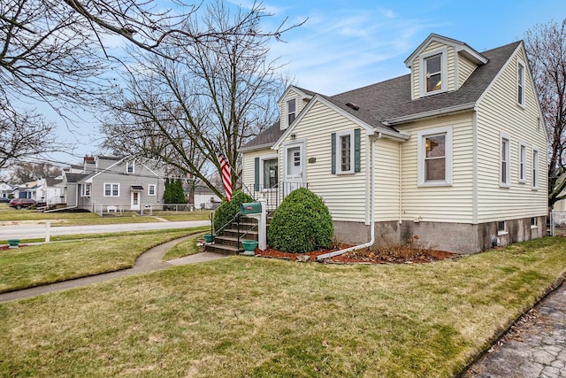 17958 Escanaba Ave, Lansing, IL 60438 - view of front facade featuring roof with shingles, a front lawn, and a residential view
