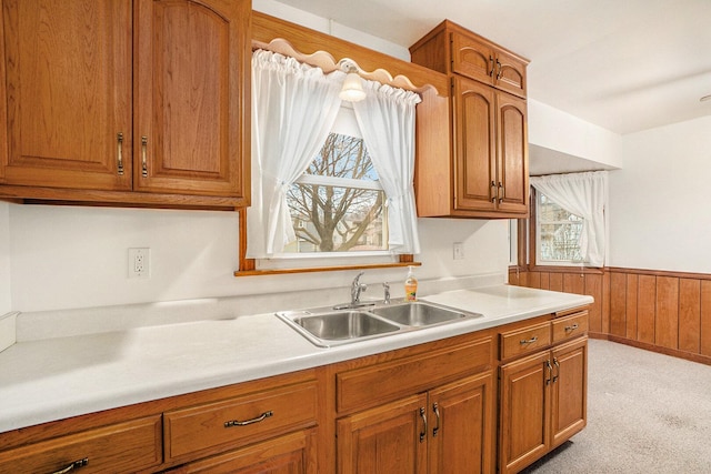 17958 Escanaba Ave, Lansing, IL 60438 - kitchen featuring healthy amount of natural light, brown cabinetry, light countertops, wainscoting, and wood walls